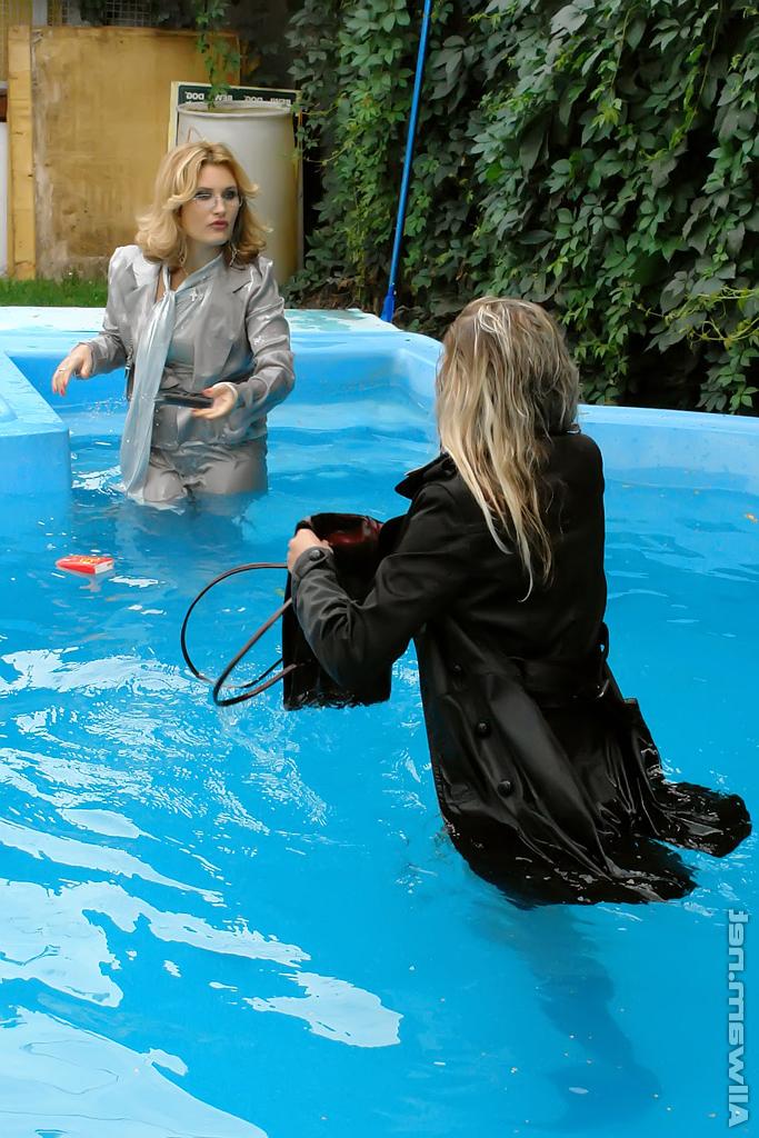 16P Tatiana Milovani has some fully clothed fun with her friend in the pool