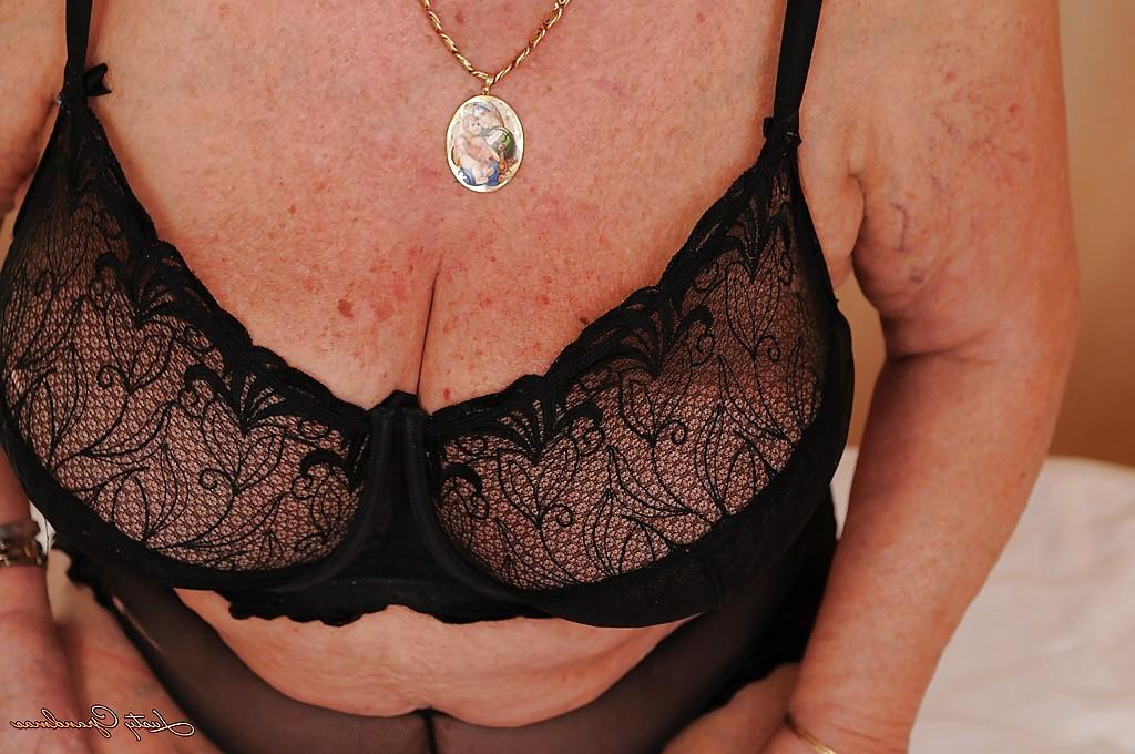 16P Fatty granny with massive flabby jugs taking off her lingerie on the bed