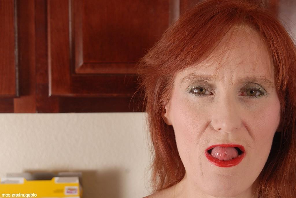 16P Redhead granny Debra is lying naked on the floor and masturbating