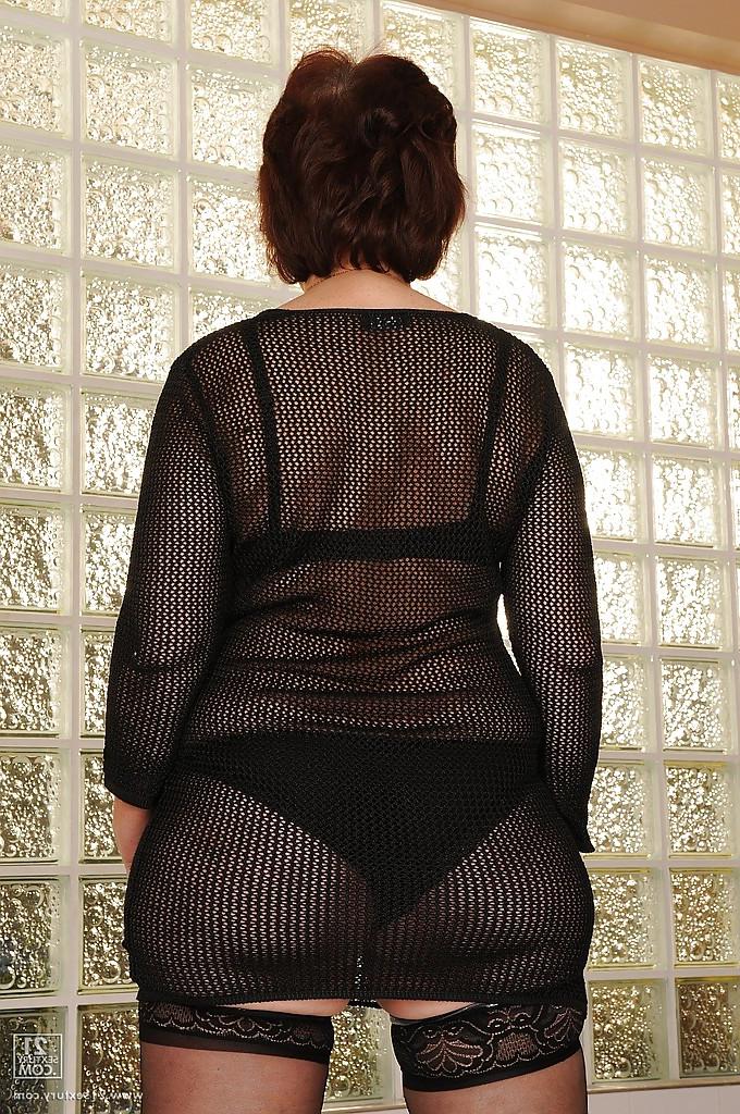 16P Slutty granny in stockings strips to her naked body and hairy pussy