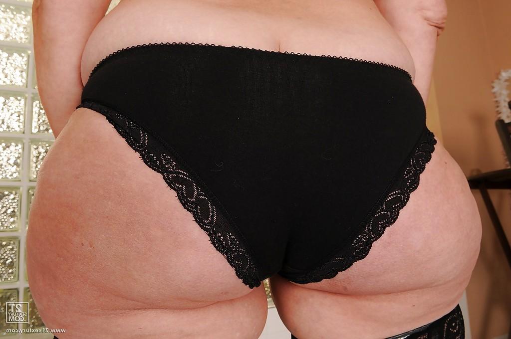 16P Slutty granny in stockings strips to her naked body and hairy pussy