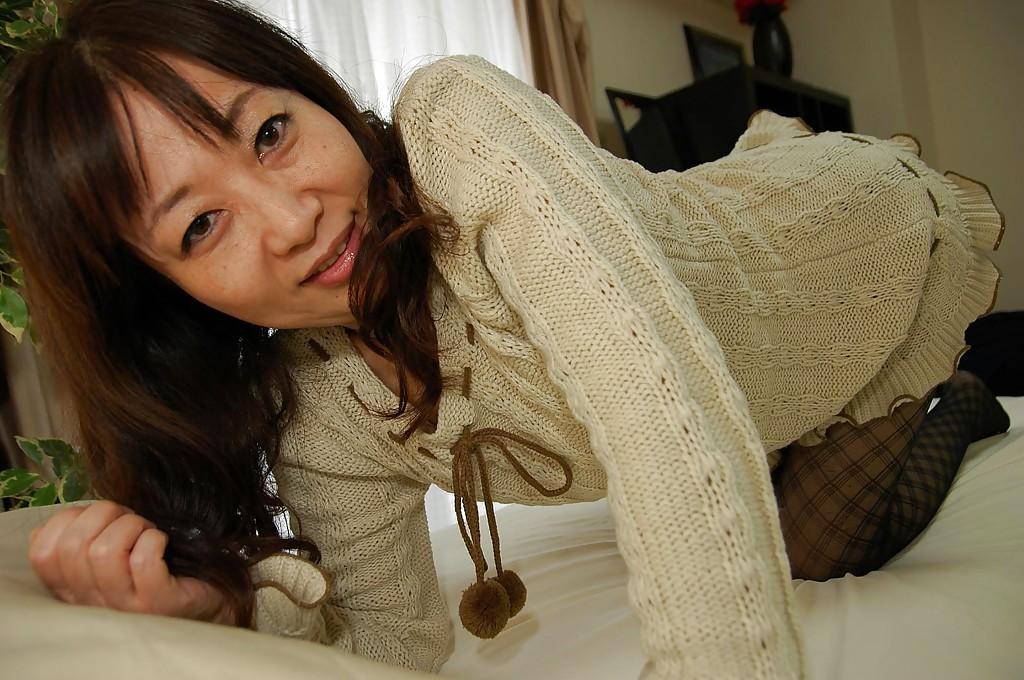 16P Asian lady in pantyhose Yukiko Moritani undressing and posing on the couch