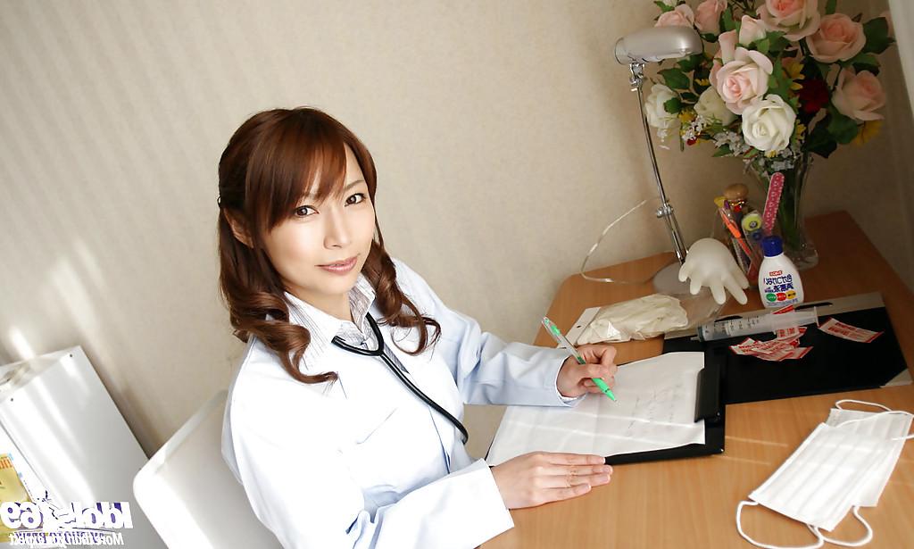 15P Naughty asian doctor in glasses revealing her nice tits with hard nipples