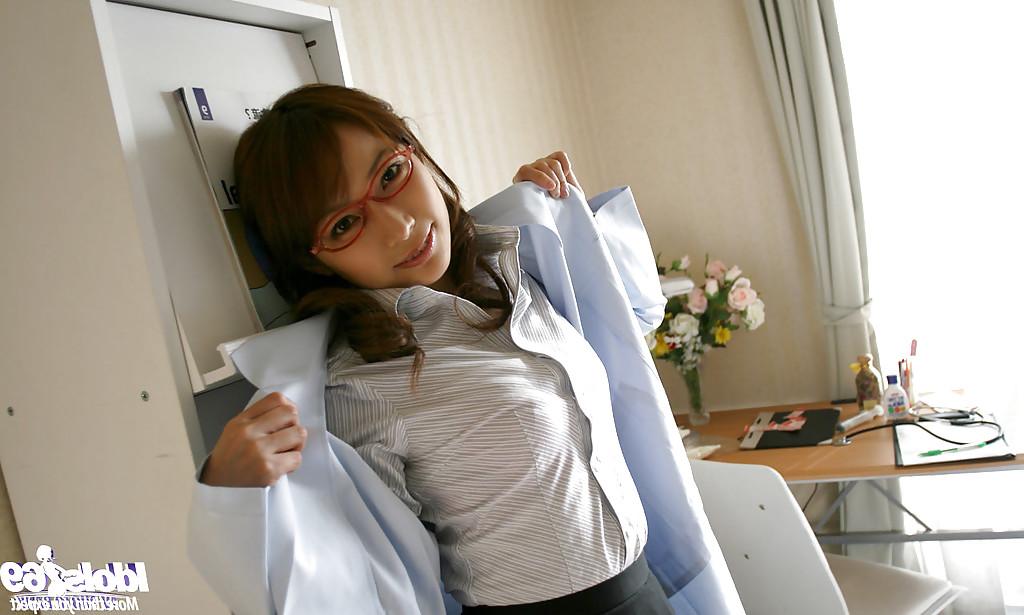 15P Naughty asian doctor in glasses revealing her nice tits with hard nipples