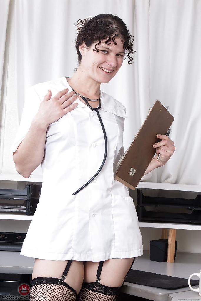 16P Mature brunette Sunshine shedding doctor garb before exposing hairy twat