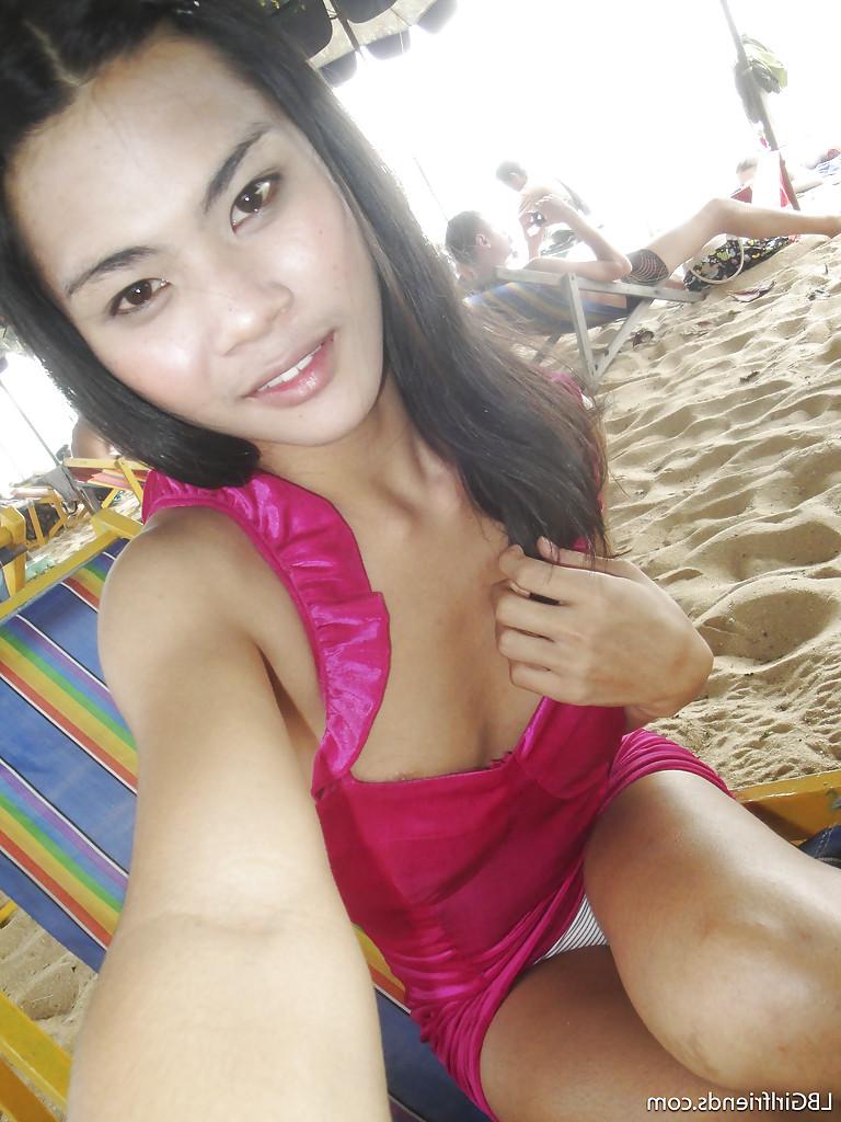 16P Gorgeous Thai shemale June bares naked teen body outdoors on the beach