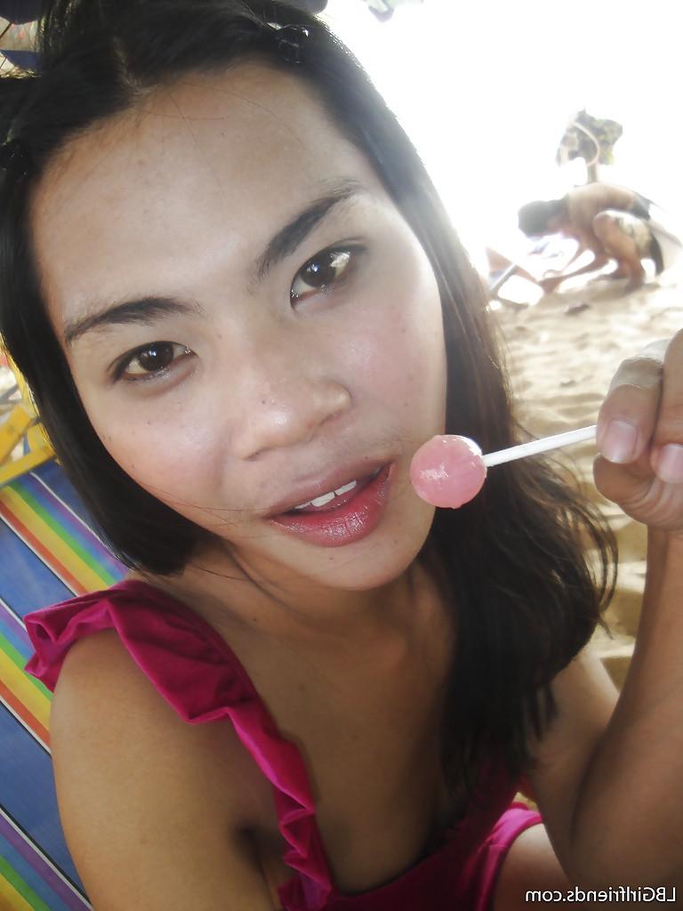 16P Gorgeous Thai shemale June bares naked teen body outdoors on the beach