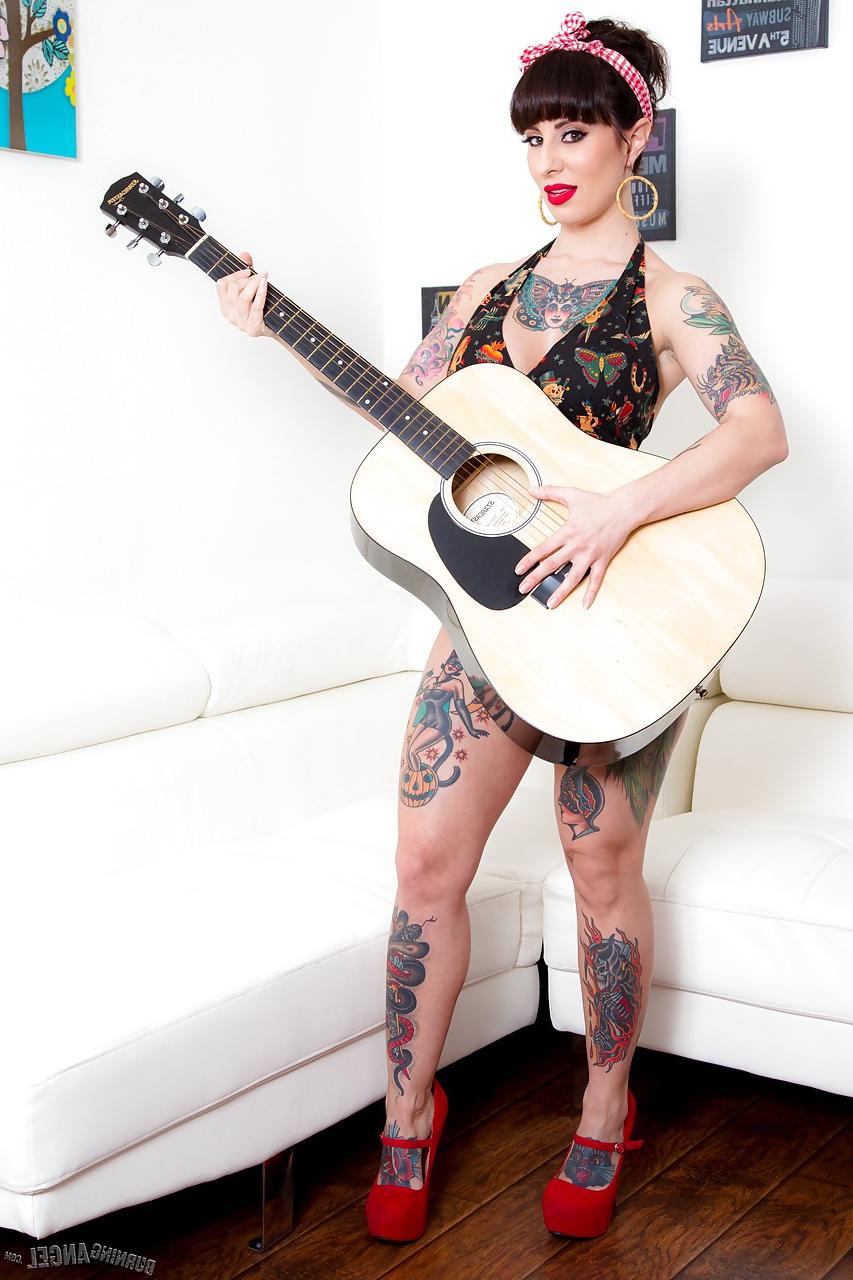 15P Long legged tattooed MILF Dollie Darko undressing to show spread ass