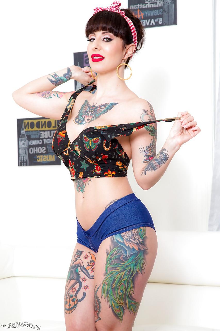 15P Long legged tattooed MILF Dollie Darko undressing to show spread ass