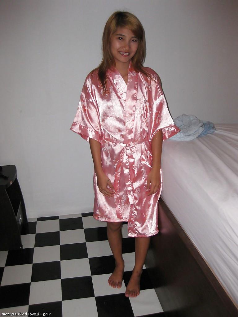 14P Sweet asian babe lowering her panties and flashing her hairy cooter