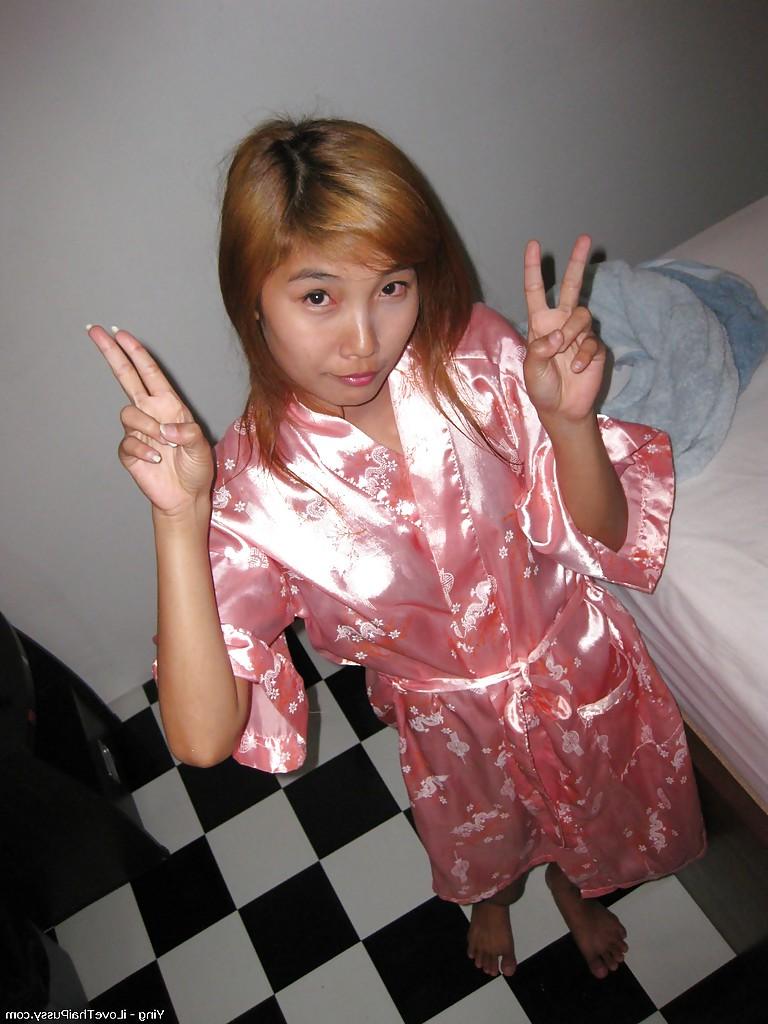 14P Sweet asian babe lowering her panties and flashing her hairy cooter
