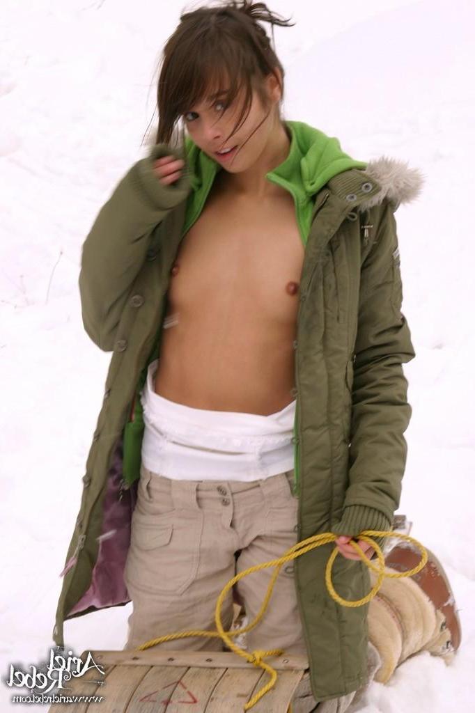 15P Pictures of Ariel Rebel flashing her tits in the snow