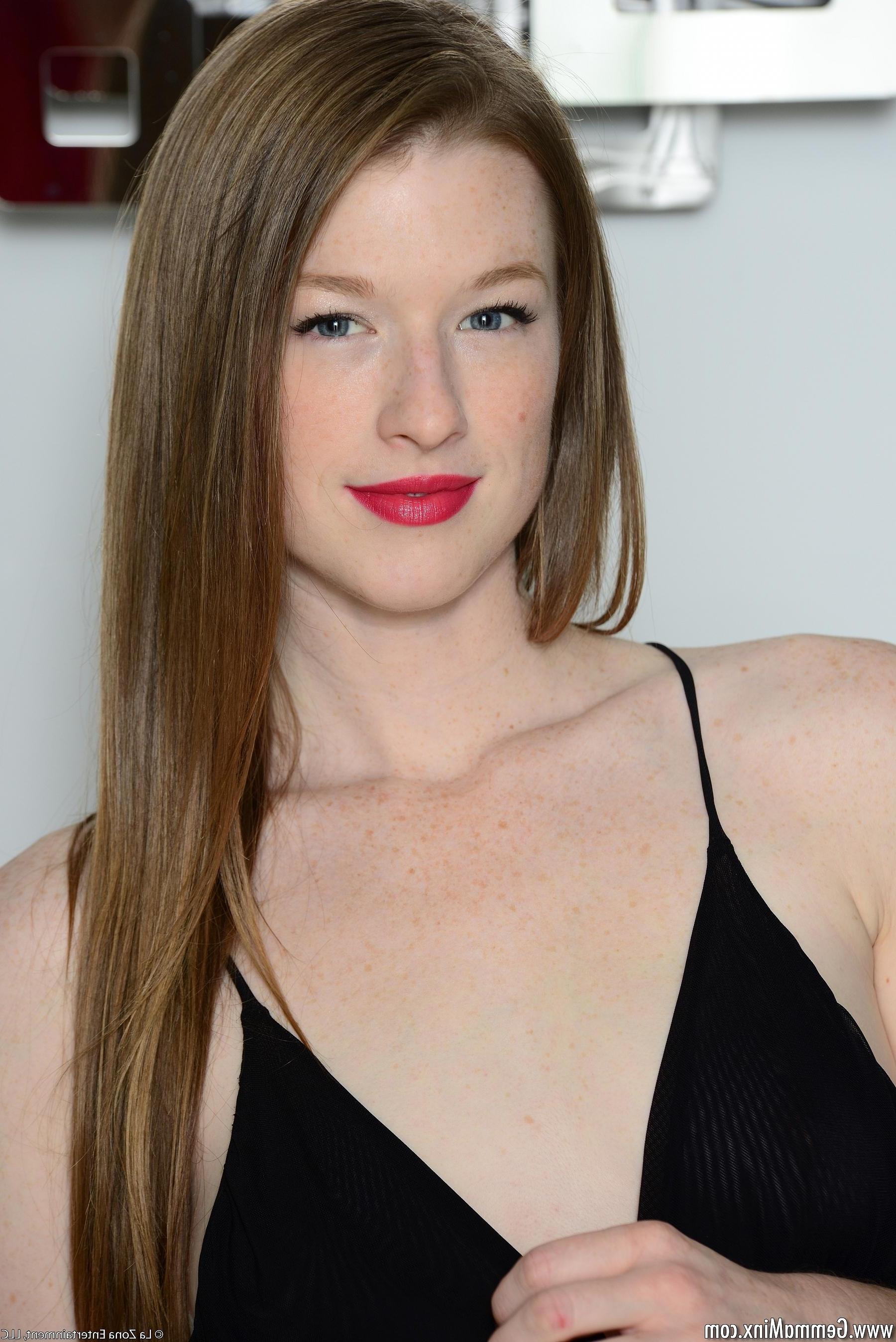 15P Gemma Minx looks sultry in her black bodysuit and red lipstick as she masturbates