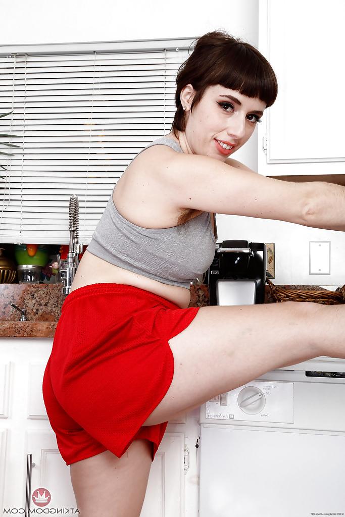 16P Hirsute solo model Simone Delilah tugging on exposed pussy lips in kitchen