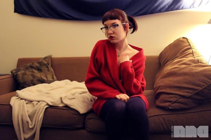 15P Hot alt girl Jesse Caits poses in her glasses and stockings on the couch