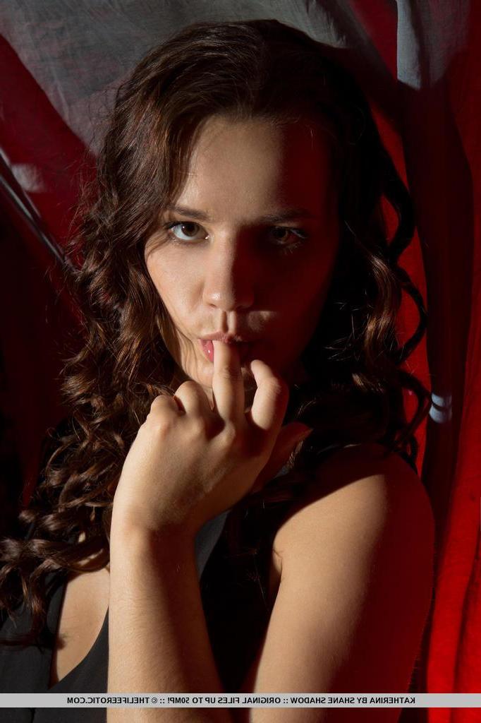 16P Dark haired model Katherina pulls aside her black panties to touch her pussy