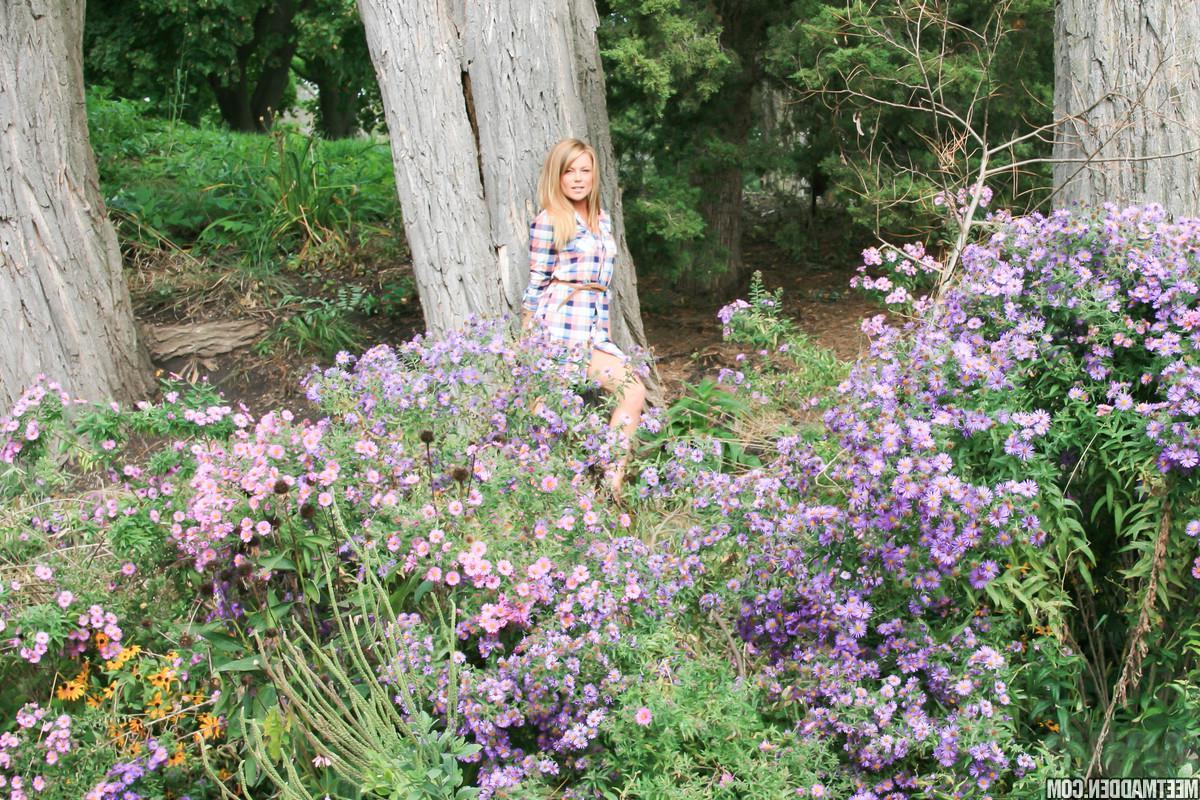 15P Blonde babe Madden strips for you in the flower patch
