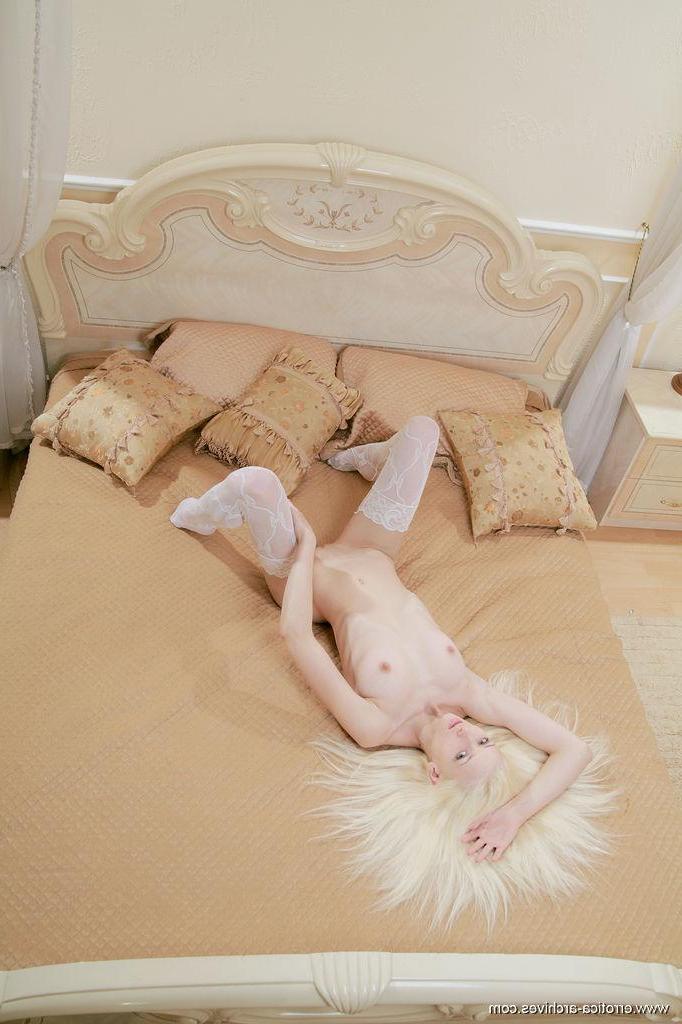 16P Stunning blonde girl Nika N dresses in her white lace lingerie and waits for you in bed