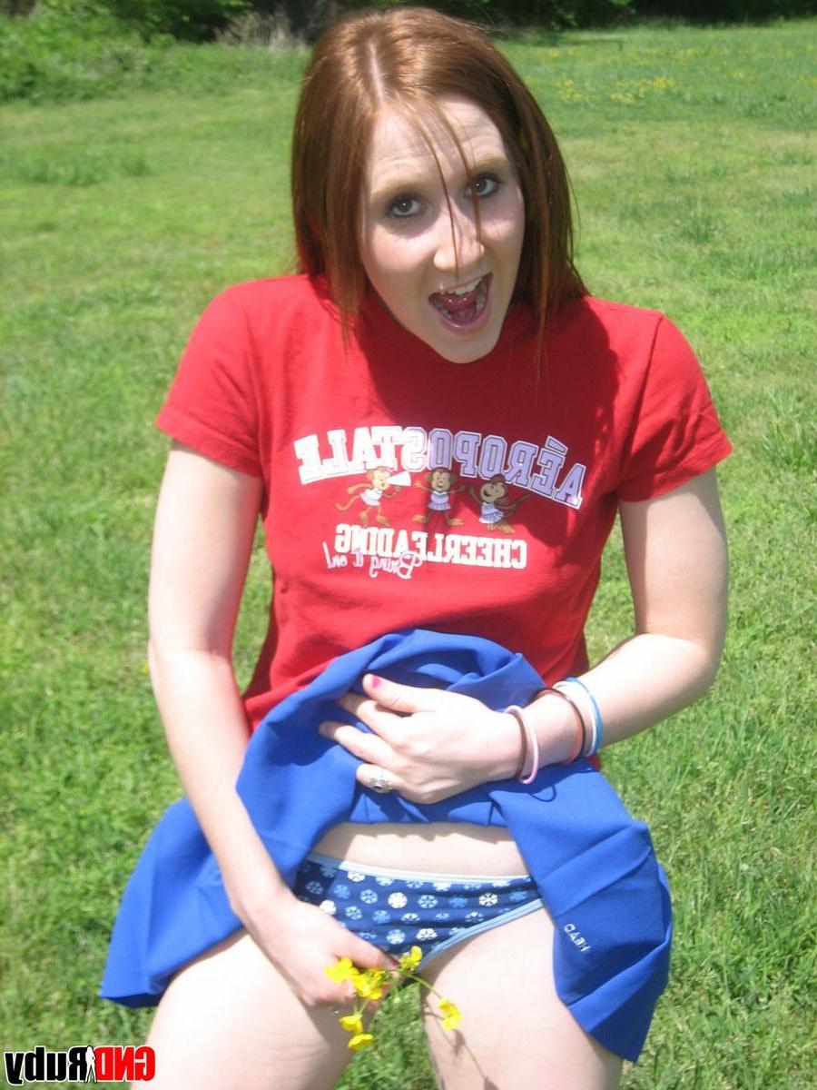 12P Teenage slut Ruby flashes her perky tits out in the park while picking flowers