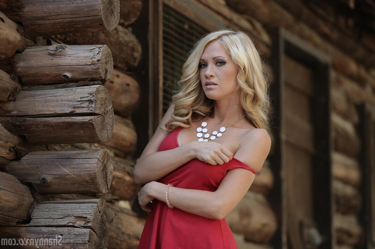 15P Shannyn Xo poses in the woods in her sexy red dress and high heels