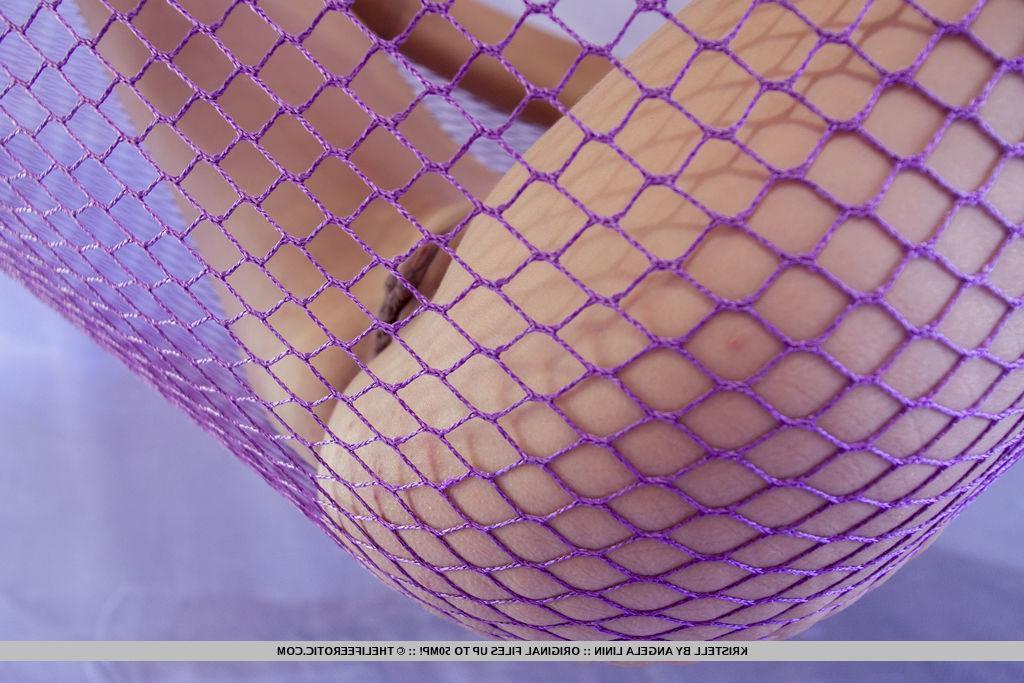16P Blonde beauty Kristell spreads her legs in a net in "Risque"