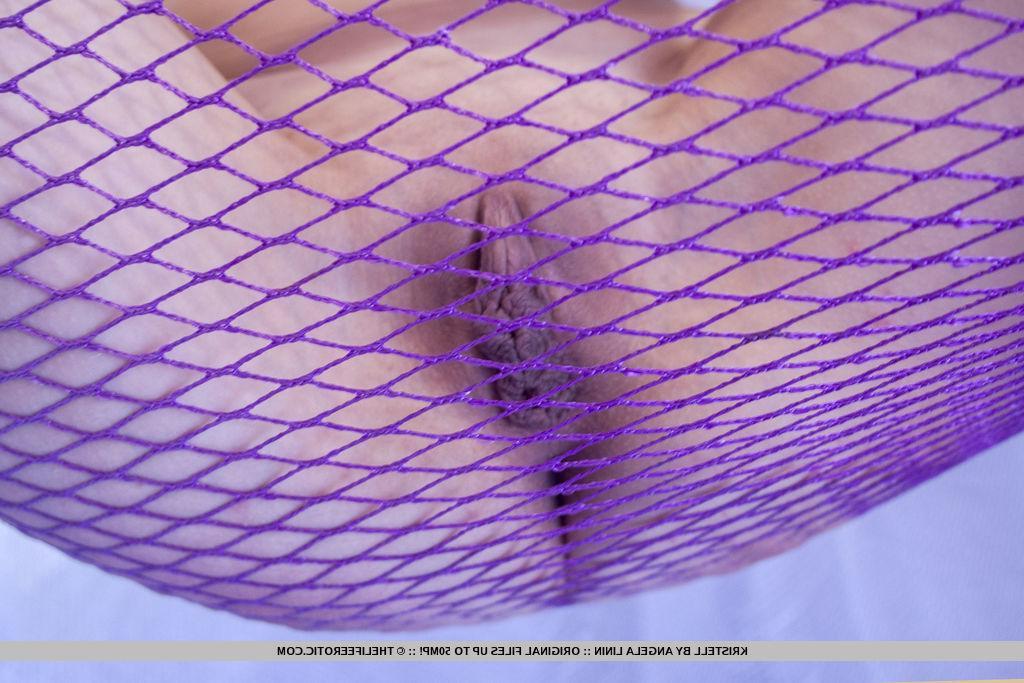 16P Blonde beauty Kristell spreads her legs in a net in "Risque"