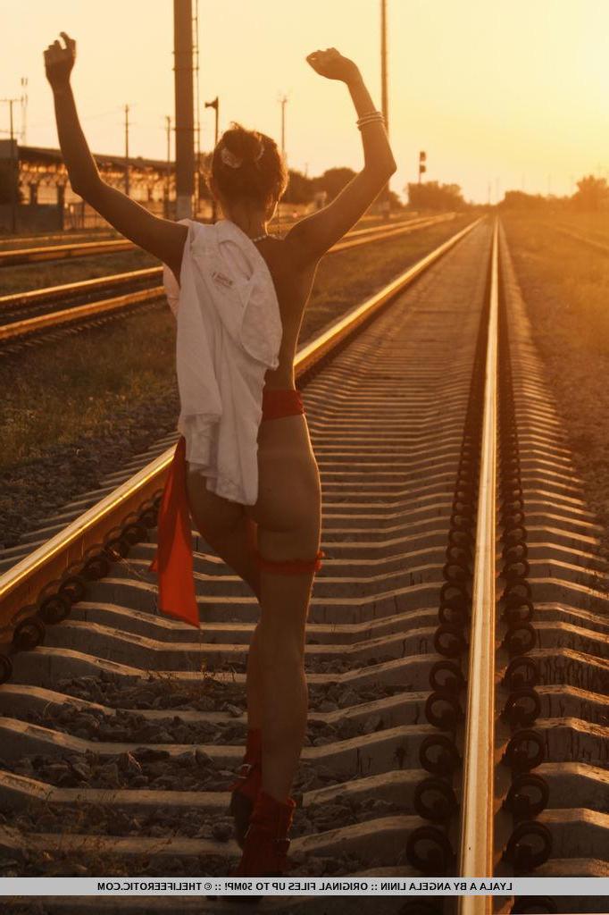 16P Brunette babe Lyala A pulls down her panties on the train tracks