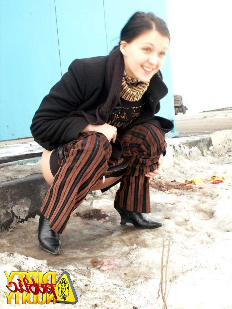 15P Melany pissing behind the busstop