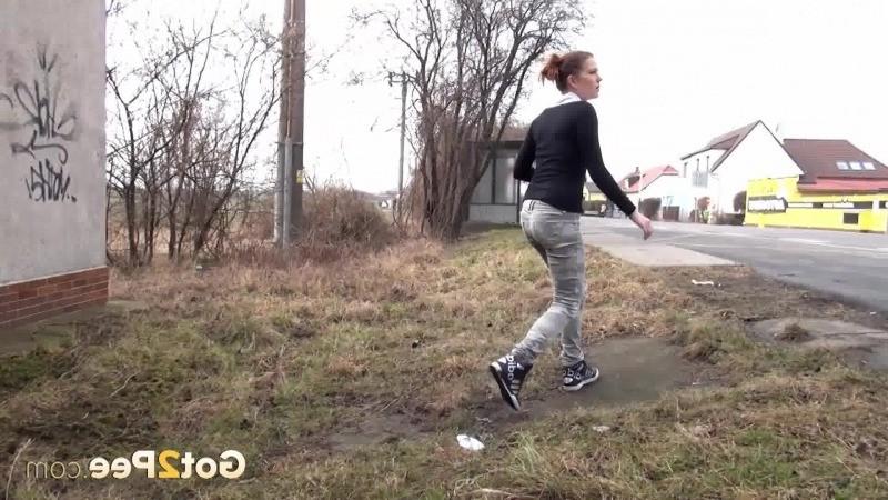 15P Brunette girl needs to pee while walking by a road