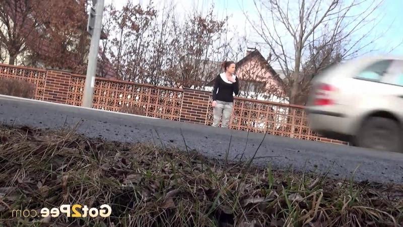 15P Brunette girl needs to pee while walking by a road