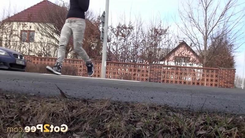 15P Brunette girl needs to pee while walking by a road