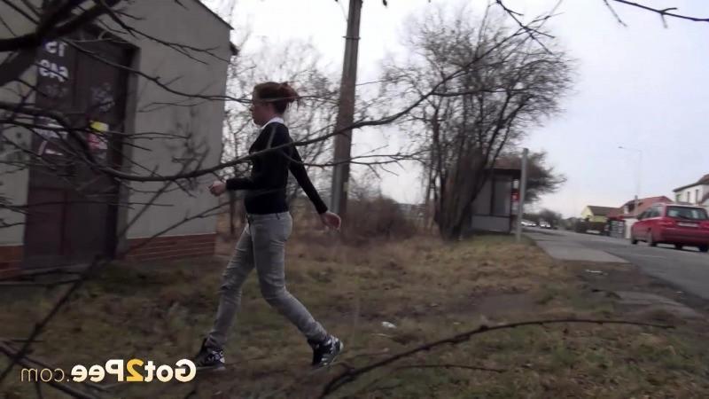 15P Brunette girl needs to pee while walking by a road