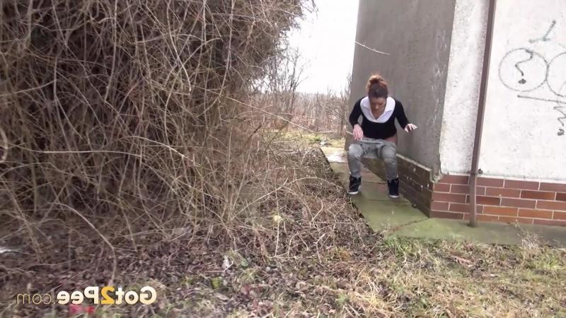 15P Brunette girl needs to pee while walking by a road