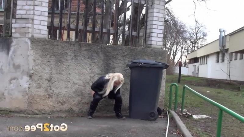 15P A pretty blonde pulls down her trousers to pee