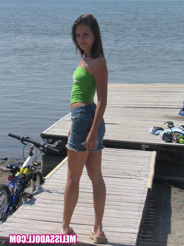 15P Gorgeous young brunette Melissa Doll teasing outdoors