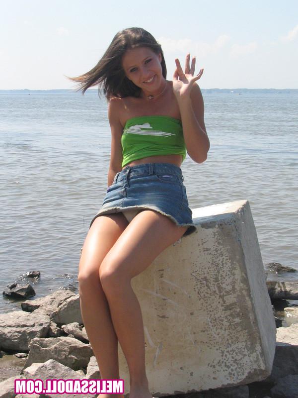 15P Gorgeous young brunette Melissa Doll teasing outdoors