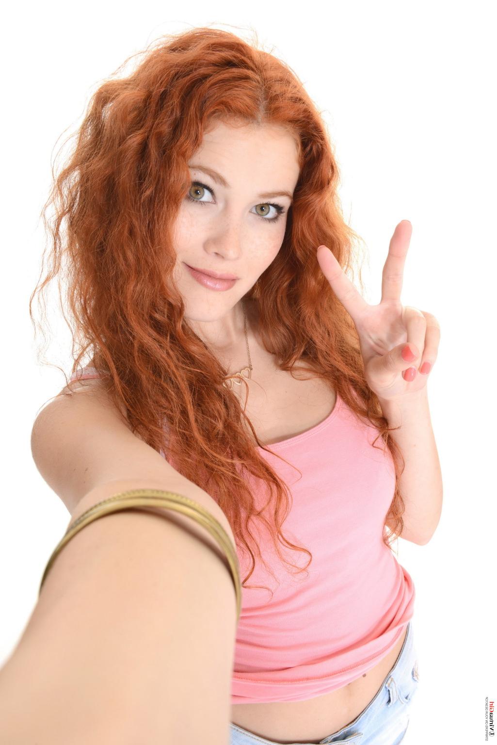 15P Sexy long legged redhead girl stripping