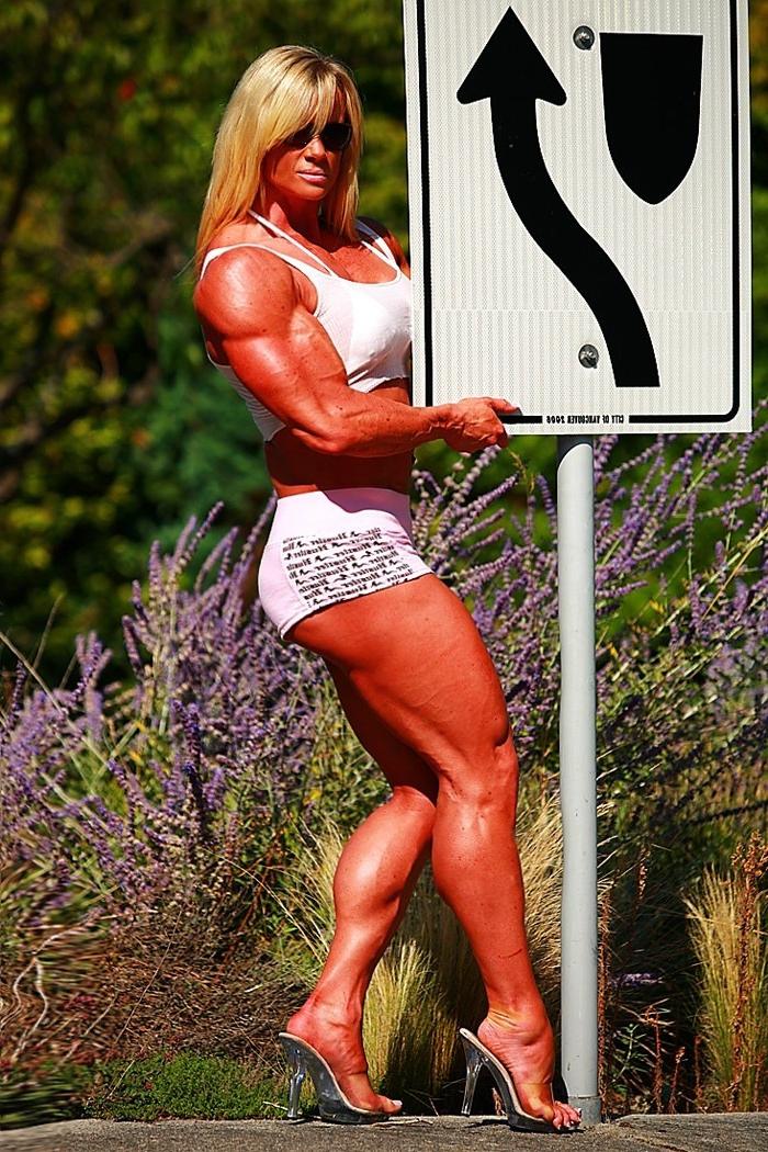 12P Massive ripped muscular woman posing outdoors