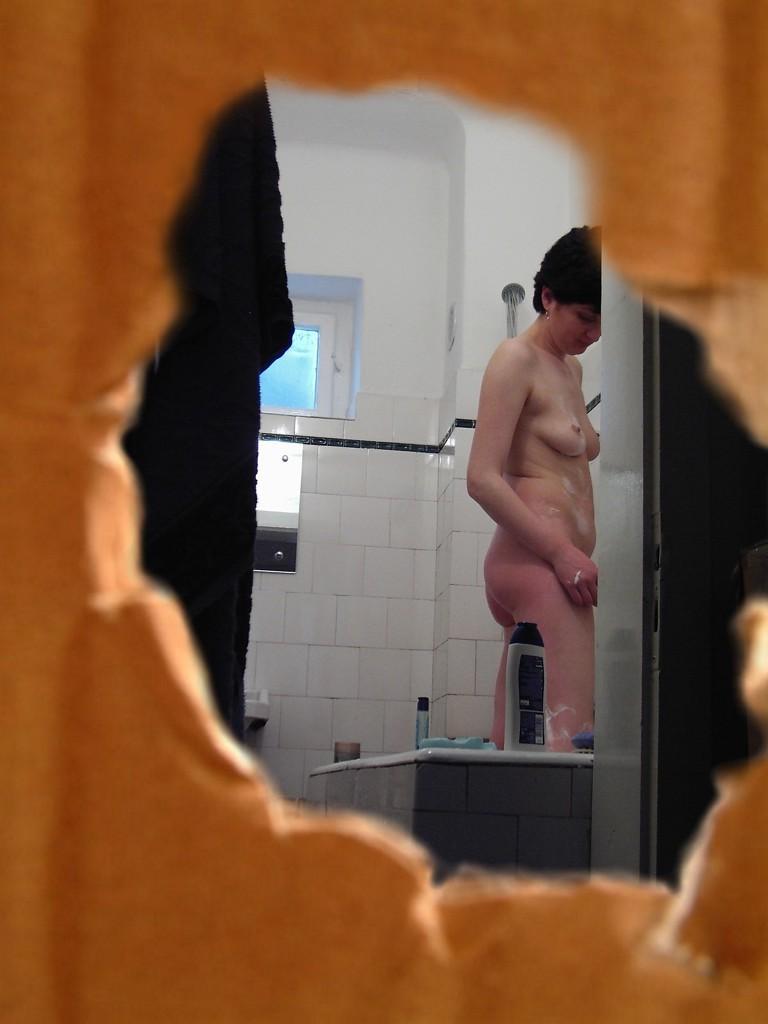 16P Voyeur peeks at brunette chick shaving her legs in the shower