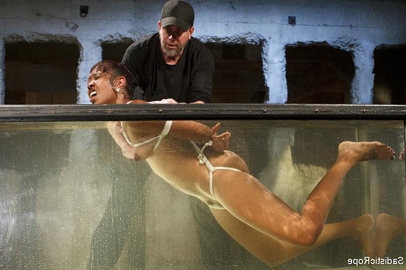 16P Lotus Lain ebony gets the bondage and water treatment with squirting orgasms