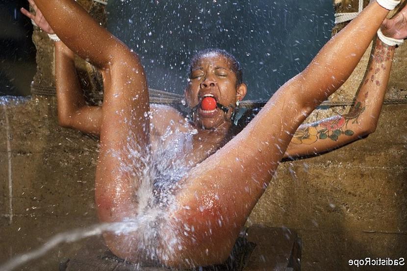 16P Lotus Lain ebony gets the bondage and water treatment with squirting orgasms