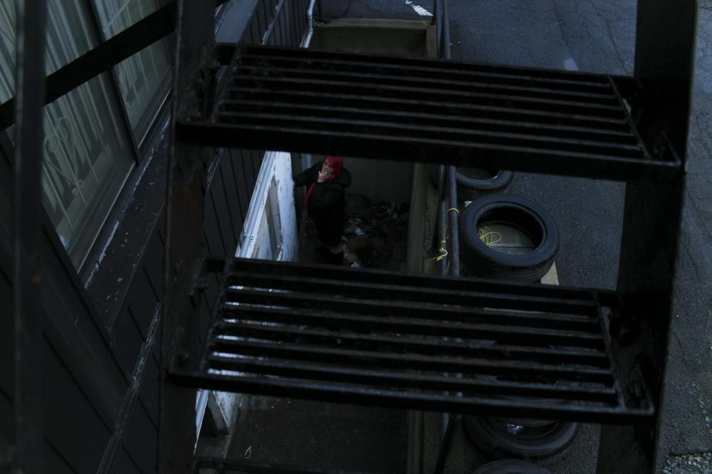 16P Marcy is tied tight into a tiny little cage on wheels.