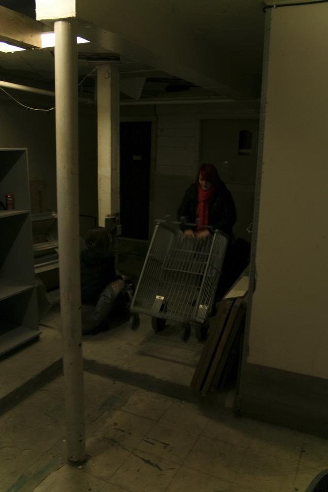 16P Marcy is tied tight into a tiny little cage on wheels.