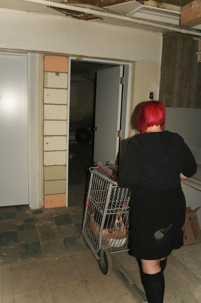 16P Marcy is tied tight into a tiny little cage on wheels.