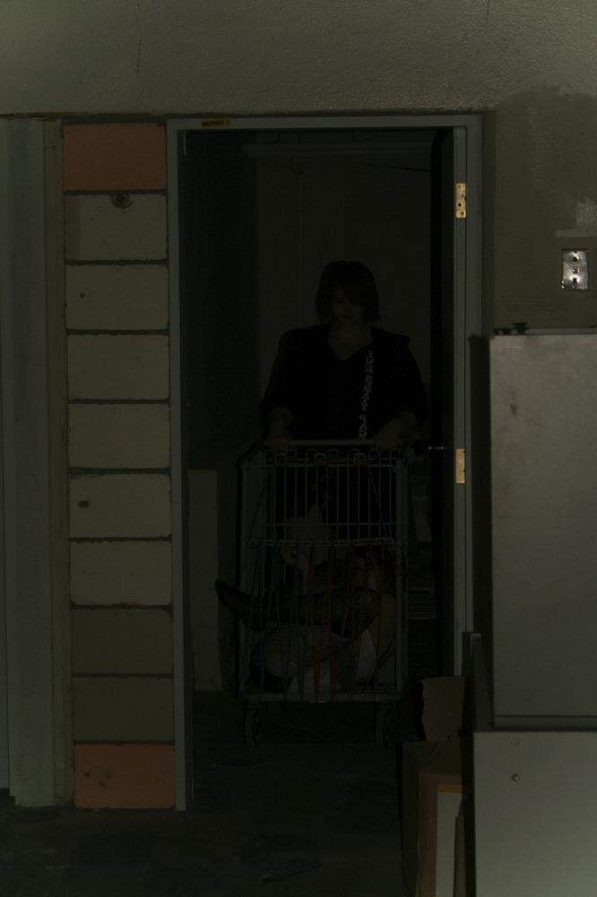 16P Marcy is tied tight into a tiny little cage on wheels.