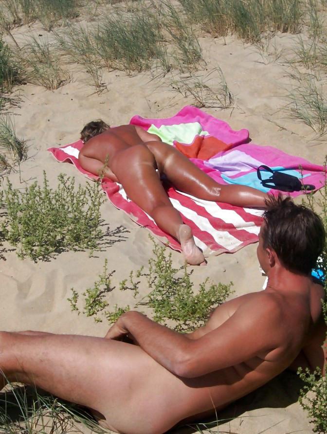 15P All eyes are on this big breasted brunette as she sunbathes