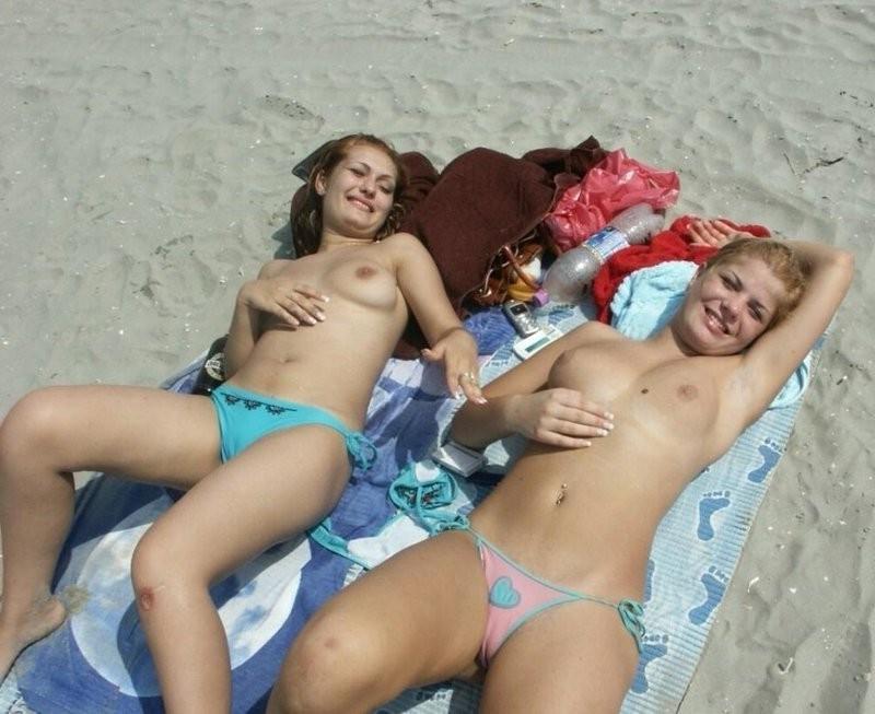 15P Watch this sexy blonde teen lay in the water naked