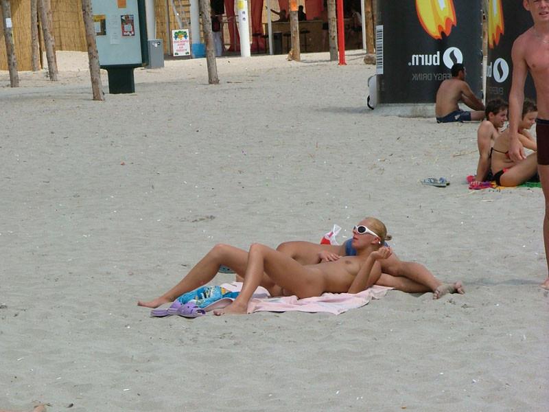 15P Naughty babe shows off her privates on the sand