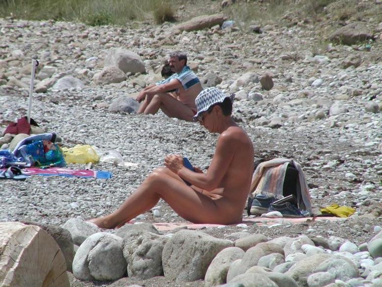 15P Watch this sexy brunette babe lay in the water naked