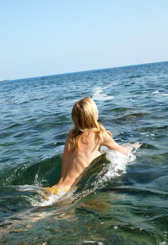 15P Watch this sexy blonde teen lay in the water naked